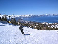 Man skiing slope overlooking Lake Tahoe

